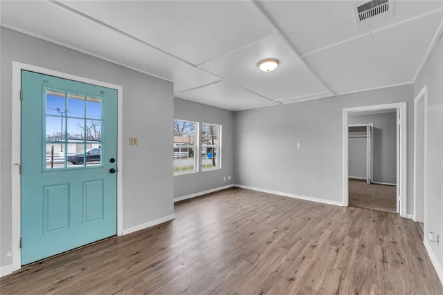 wooden floor in an empty room with a window