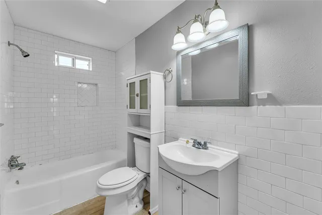a bathroom with a sink toilet tub and shower