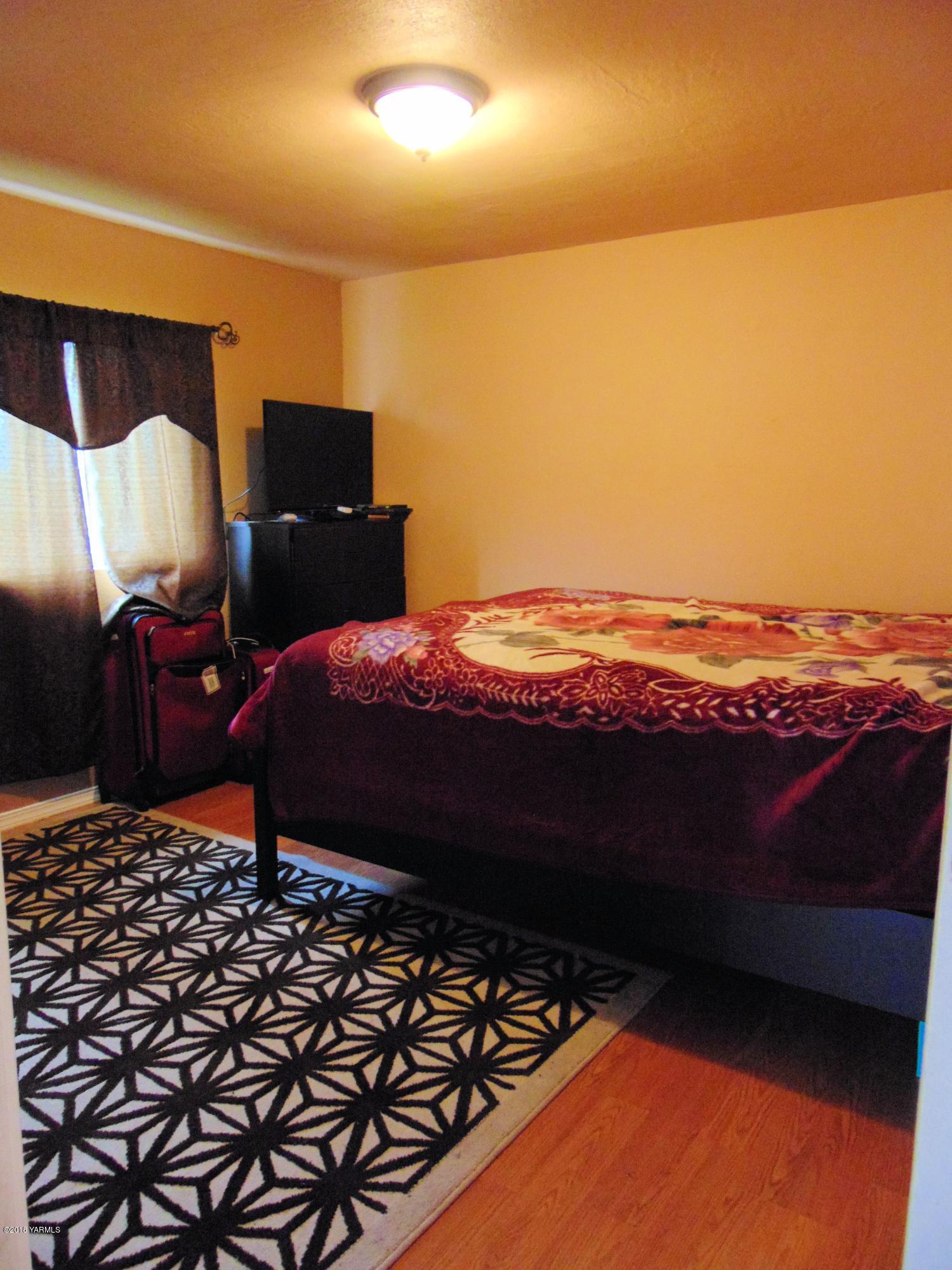 1520 Houghton Road Zillah, WA 98953 - Photo 5 of 15 a bedroom with a bed and a night stand