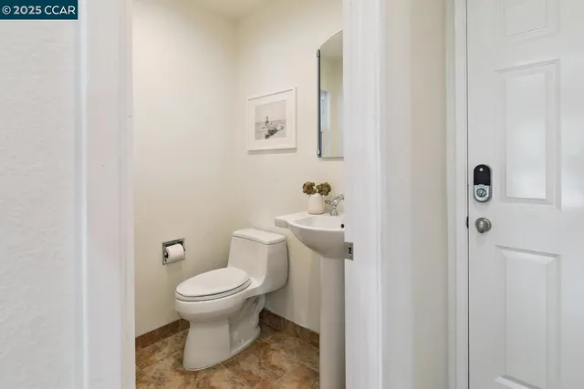a white toilet sitting next to a bathroom sink