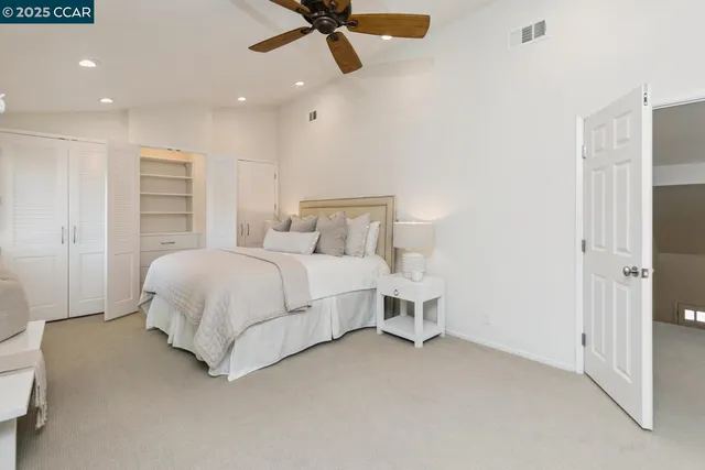 a bedroom with a bed and cabinets