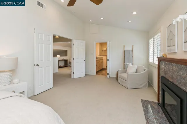 a spacious bedroom with a bed and a couch