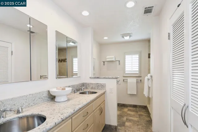 a bathroom with a sink double vanity and a mirror