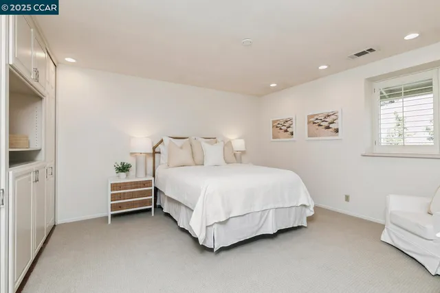 a bedroom with a bed and a couch