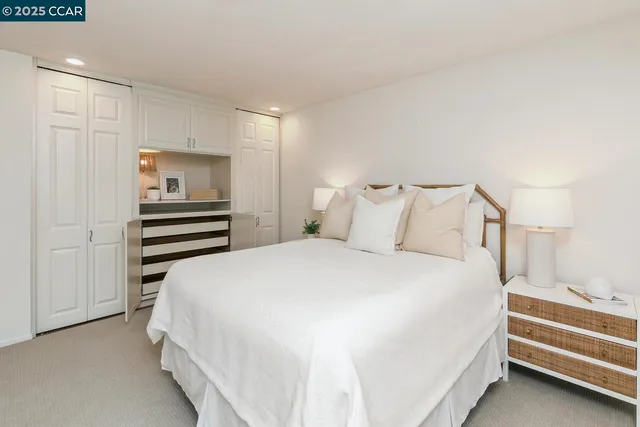 a bedroom with a bed and a view of closet