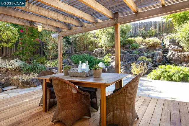 a view of a patio with table and chairs and potted plants