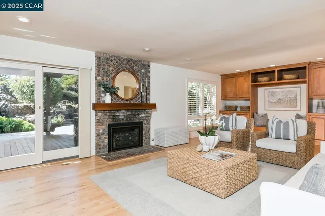 a living room with furniture a window and a fireplace