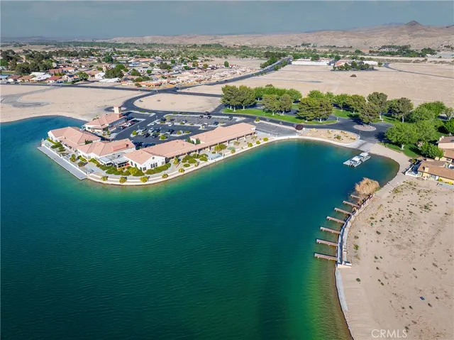 an aerial view of a house with a garden and lake view