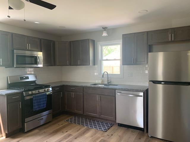 736-1 Juniper Road Valparaiso, IN 46385 - Photo 8 of 30 a kitchen with a sink a refrigerator and a stove top oven