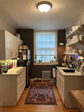 a kitchen with stainless steel appliances granite countertop a stove top oven and cabinets