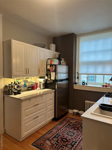 a kitchen with refrigerator and cabinets