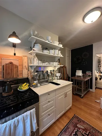 a kitchen with a sink and wooden cabinets