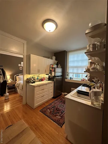 a kitchen with stainless steel appliances kitchen island granite countertop a sink stove and cabinets