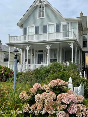 a front view of a house with a yard and plants
