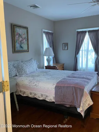 a bedroom with a bed and a painting on the wall