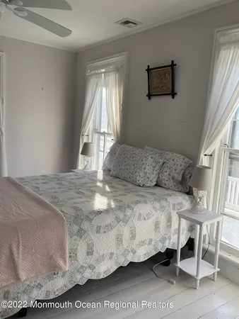 a bedroom with a bed a table and chair
