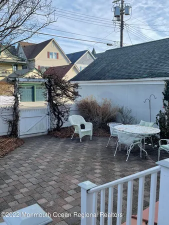 a backyard of a house with table and chairs