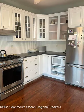 a kitchen with stainless steel appliances granite countertop a stove and a refrigerator