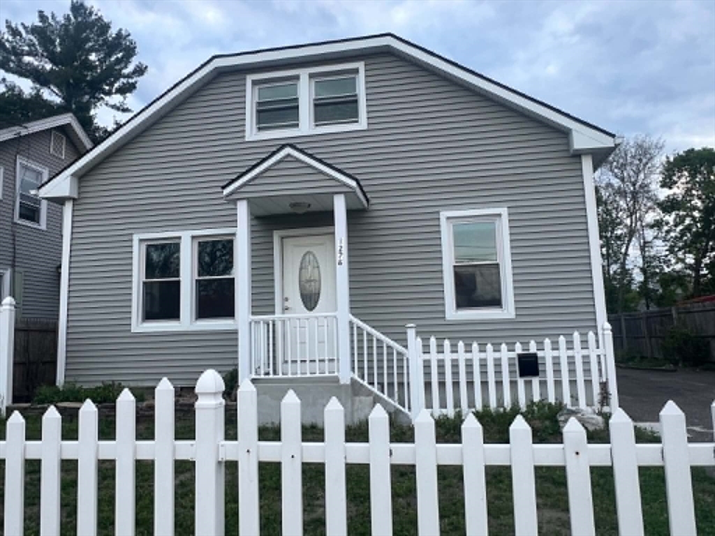 1276 Page Boulevard Springfield, MA 01104 - Photo 1 of 4 a front view of a house with a fence