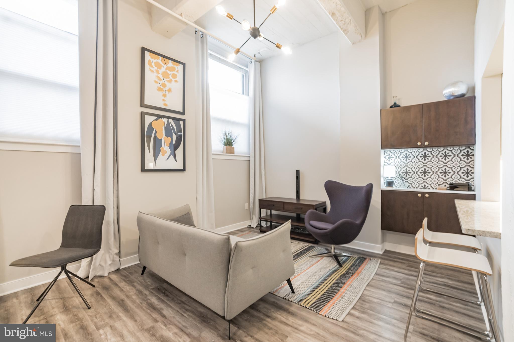 1238 Callowhill Street, Unit 101 Philadelphia, PA 19123 - Photo 1 of 17 a living room with furniture and a window
