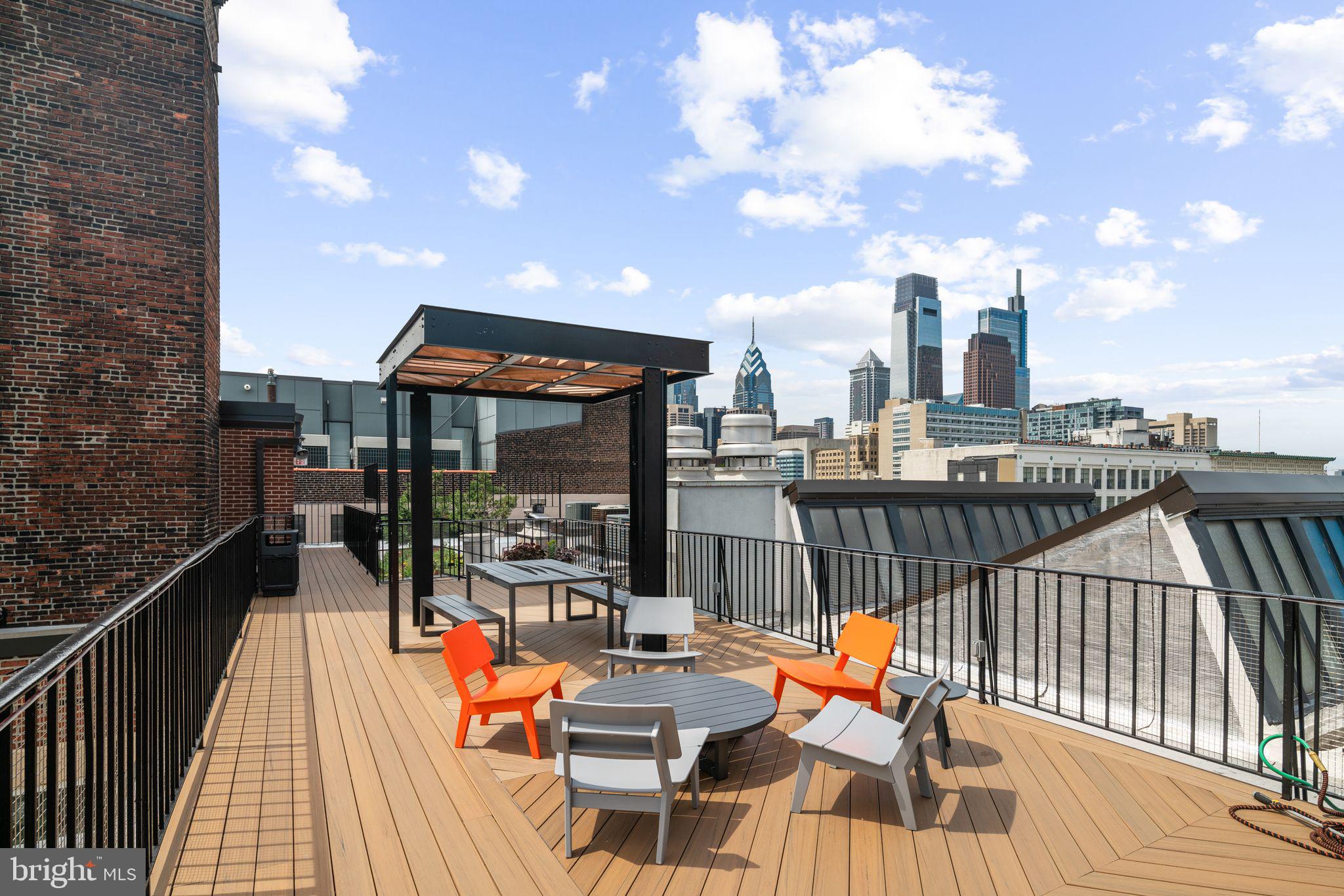 1238 Callowhill Street, Unit 101 Philadelphia, PA 19123 - Photo 15 of 17 a view of balcony with chairs and wooden fence
