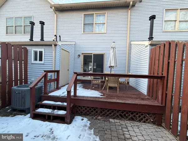 a view of a deck with couches floor to ceiling window with wooden floor