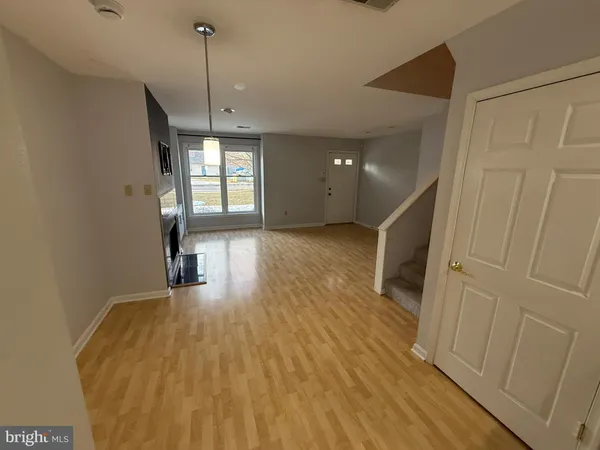 a view of a room with wooden floor and window