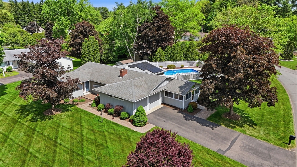 an aerial view of a house with a yard basket ball court and outdoor seating