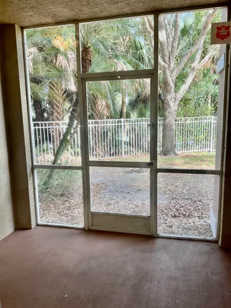 an empty room with wooden floor and a swing