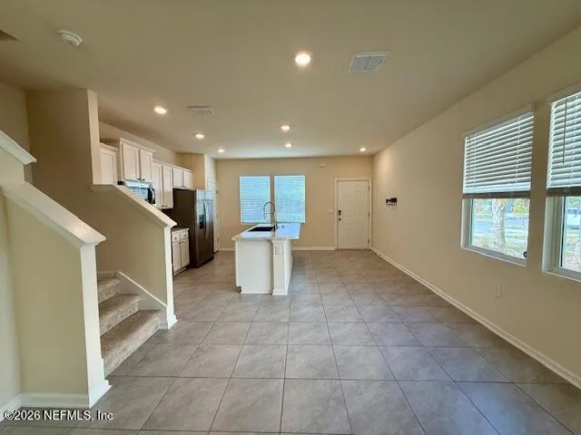 a view of a kitchen with furniture and a window