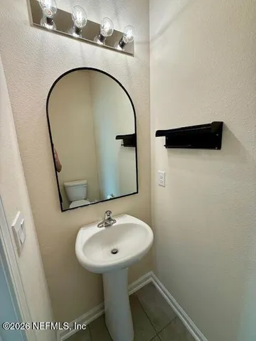 a bathroom with a sink and mirror