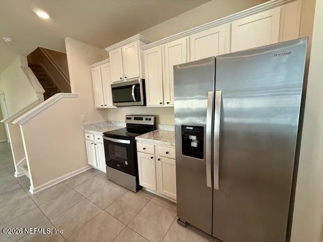 a kitchen with a refrigerator stove and microwave