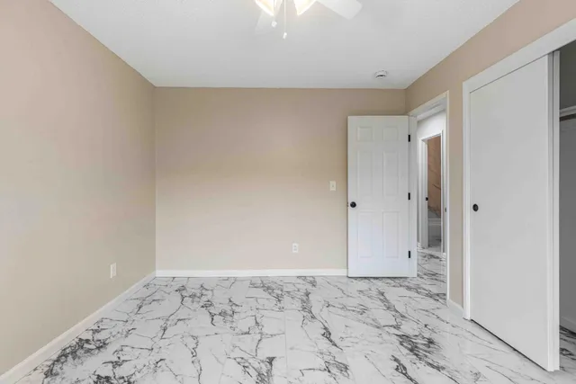 a bathroom with a toilet sink vanity tub and mirror
