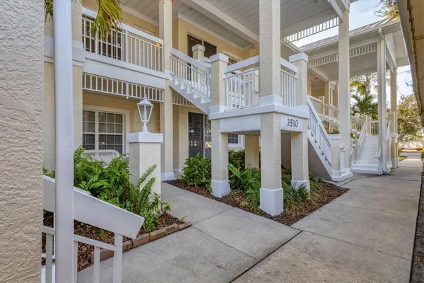 front view of a brick house with a small yard