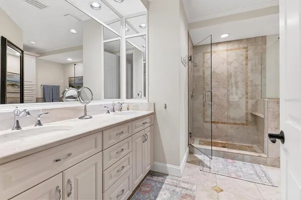 a bathroom with double sink and a mirror