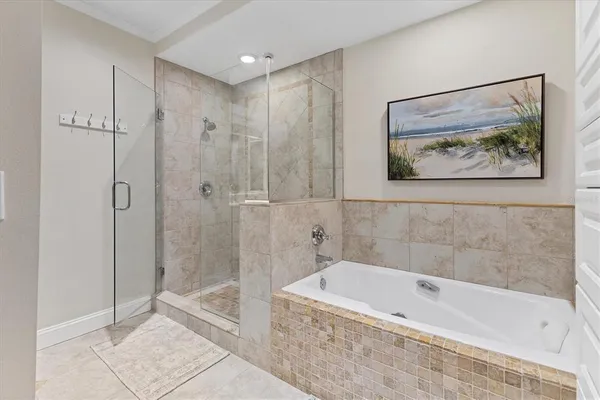 a bedroom with a bed and a dresser with mirror