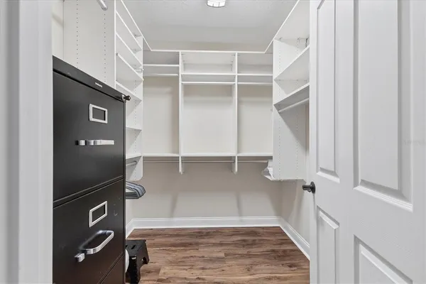 a bathroom with a toilet a sink a mirror and vanity