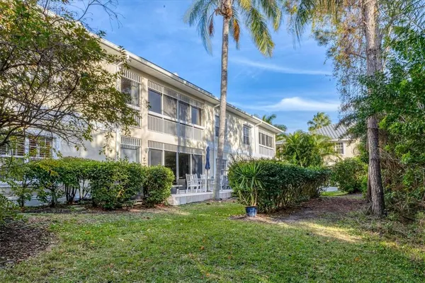 a view of a patio with furniture and garden