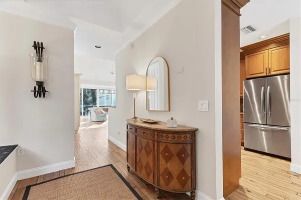 a kitchen with stainless steel appliances granite countertop a refrigerator a stove and a sink with wooden floor