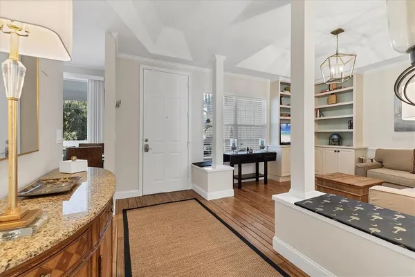 a living room with furniture a dining table and a large window