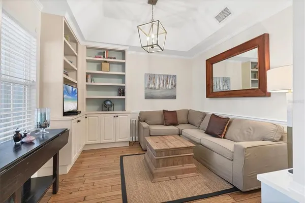 a living room with furniture and a chandelier