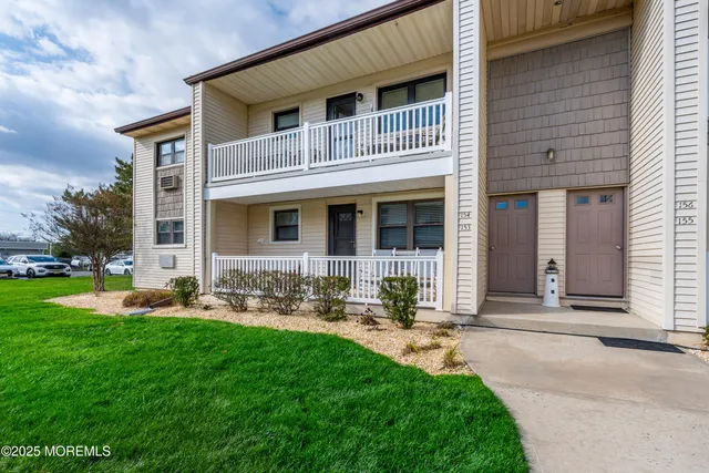 a front view of a house with garden and patio