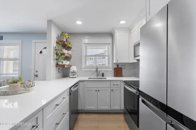 a kitchen with a sink stove and cabinets