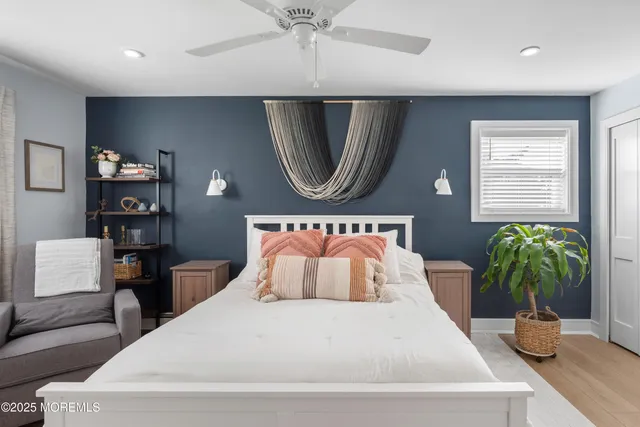 a bedroom with a large bed and a potted plant