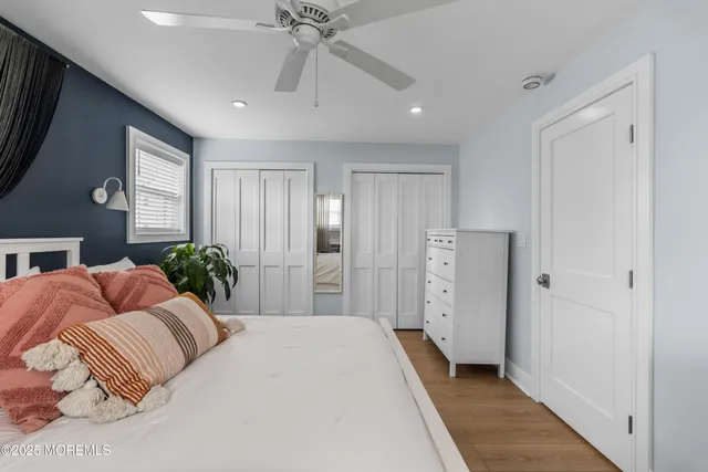 a spacious bedroom with a large bed and a chandelier