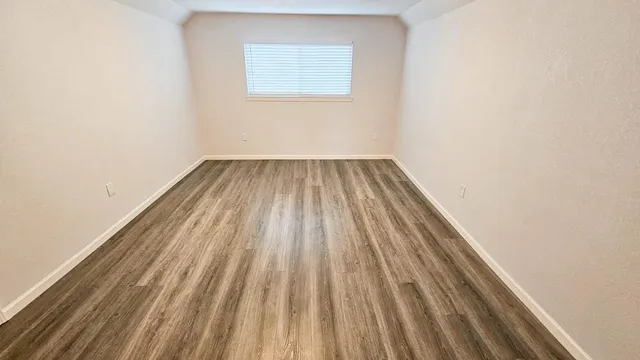 a view of a room with wooden floor and deck