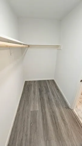 a view of a room with wooden floor