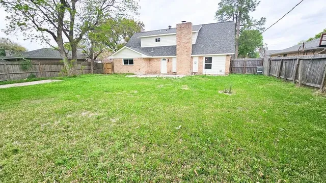 a view of a house with a yard and sitting area
