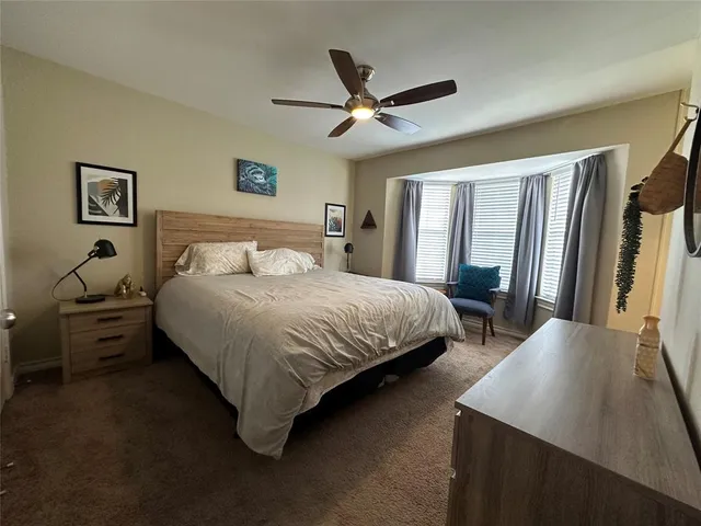 a bedroom with a bed and a large mirror