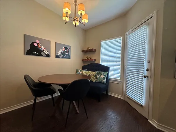 a view of a dining room with furniture wooden floor and chandelier